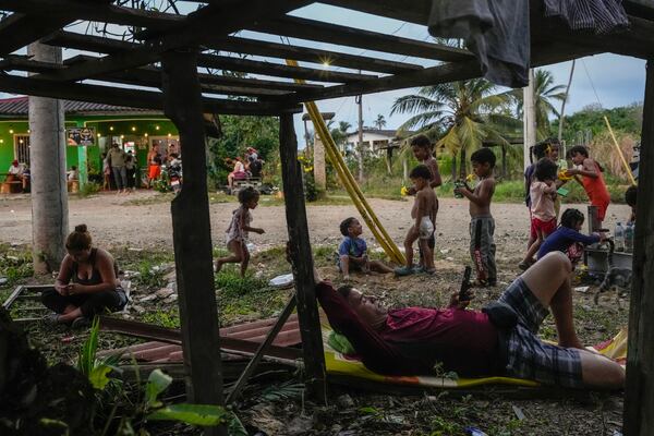 Migrants wait around in a shelter in Palenque, Panama, Wednesday, Feb. 26, 2025. The migrants are returning from southern Mexico after giving up on reaching the U.S., a reverse flow triggered by the Trump administration's immigration crackdown. (AP Photo/Matias Delacroix)