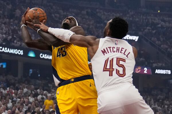 Indiana Pacers forward Pascal Siakam (43) is fouled by Cleveland Cavaliers guard Donovan Mitchell (45) in the first half during Game 2 in the Eastern Conference semifinals of the NBA basketball playoffs, Tuesday, May 6, 2025, in Cleveland. (AP Photo/Sue Ogrocki)