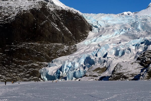 FILE - People walk near the Mendenhall Glacier on Feb. 9, 2025, in Juneau, Alaska. (AP Photo/Becky Bohrer, File)