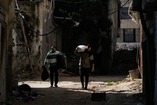 Residents of the West Bank urban refugee camp of Nur Shams evacuate their homes and carry their belongings as the Israeli military continues its operation in the area on Wednesday, Feb. 26, 2025. (AP Photo/Majdi Mohammed)