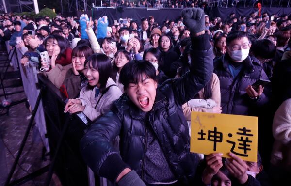 People cheer during the 2025 Taipei New Year's Party celebration in front of the Taipei City Government Building in Taipei, Taiwan, Tuesday, Dec. 31, 2024. (AP Photo/Chiang Ying-ying)