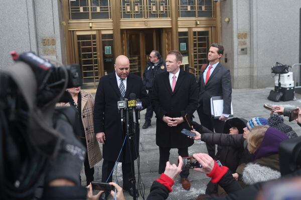 Attorney Joseph Cammarata, left, reads a statement off his phone on behalf of Rudy Giuliani outside of federal court, Thursday, Jan. 16, 2025, in New York. (AP Photo/Heather Khalifa)