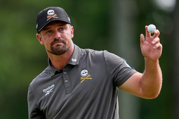 Bryson DeChambeau waves after making a putt on the ninth hole during the first round of the PGA Championship golf tournament at the Quail Hollow Club, Thursday, May 15, 2025, in Charlotte, N.C. (AP Photo/George Walker IV)