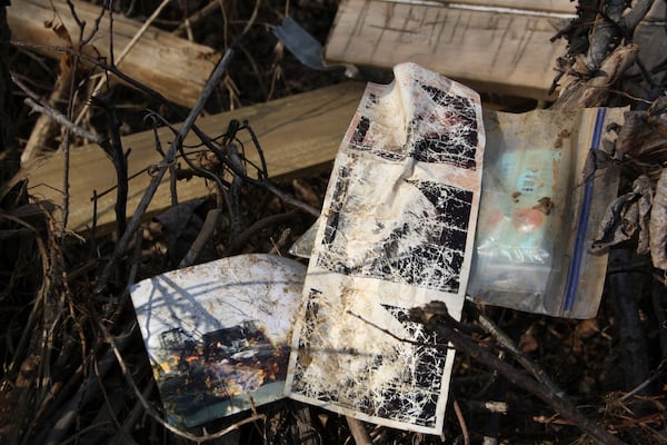 A sonogram photo strip is placed atop twigs with other lost items Jill Holtz found in the woods near a cornfield in Swannanoa, N.C., on Thursday, Feb. 6, 2025. (AP Photo/Makiya Seminera)