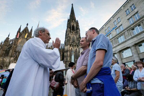 FILE - Same-sex couples take part in a public blessing ceremony in front of the Cologne Cathedral in Cologne, Germany, Sept. 20, 2023. (AP Photo/Martin Meissner, File)
