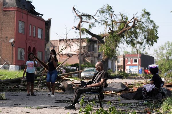 A man sits in a chair after a severe storm moved through St. Louis, Missouri, Friday, May 16, 2025. (AP Photo/Jeff Roberson)