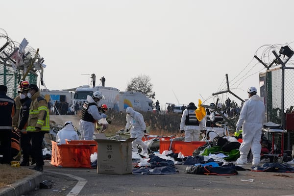 Rescue team members work outside of Muan International Airport in Muan, South Korea, Sunday, Dec. 29, 2024. (AP Photo/Ahn Young-joon)