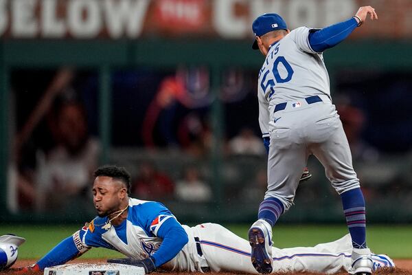 Atlanta Braves' Ozzie Albies (1) steals second base against Los Angeles Dodgers shortstop Mookie Betts (50) in the second inning of a baseball game, Saturday, May 3, 2025, in Atlanta. (AP Photo/Mike Stewart)