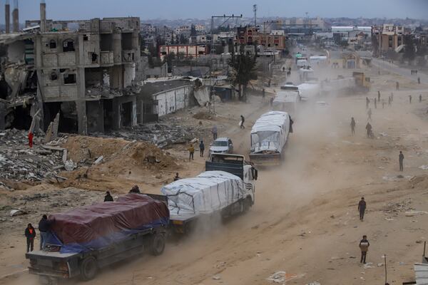 Humanitarian aid trucks enter through the Kerem Shalom crossing from Egypt into the Gaza Strip, in Rafah, Wednesday, Jan. 22, 2025, days after the ceasefire deal between Israel and Hamas came into effect. (AP Photo/Jehad Alshrafi)