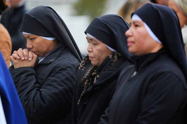 People pray for Pope Francis in front of the Agostino Gemelli Polyclinic, where the Pontiff has been hospitalized since Feb. 14, in Rome, Wednesday, Feb. 26, 2025. (AP Photo/Kirsty Wigglesworth)