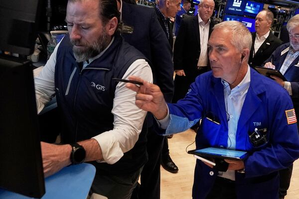 Specialist Michael Pistillo, right, and trader Timothy Nick work on the floor of the New York Stock Exchange, Thursday, May 1, 2025. (AP Photo/Richard Drew)