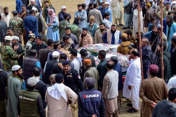 Mourners gather around a casket of a victim of the train attack, for a funeral prayer in Quetta, Pakistan's southwestern Balochistan province, Thursday March 13, 2025. (AP Photo/Arshad Butt)