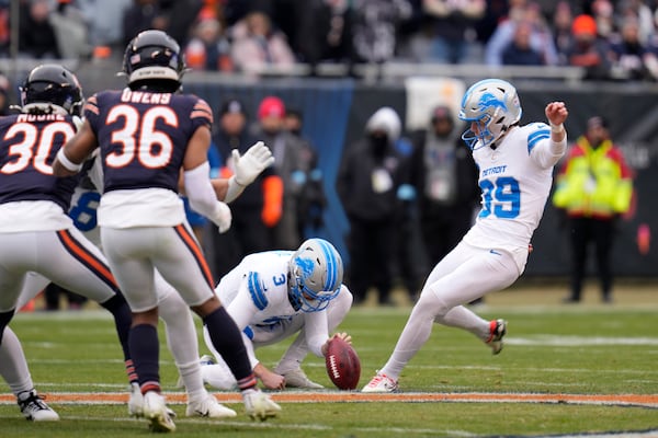 Detroit Lions place kicker Jake Bates steps into a 65-yard field goal attempt off the hold of Jack Fox, that missed right during the first half of an NFL football game against the Chicago Bears on Sunday, Dec. 22, 2024, in Chicago. (AP Photo/Erin Hooley)