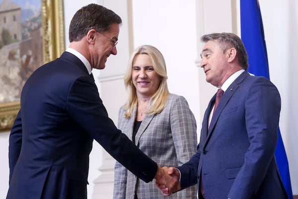 NATO Secretary General Mark Rutte, left, shakes hands with the member of the Bosnian Presidency Zeljko Komsic, right, prior to the start of their meeting in Sarajevo, Bosnia, Monday, March 10, 2025. (AP Photo/Armin Durgut)