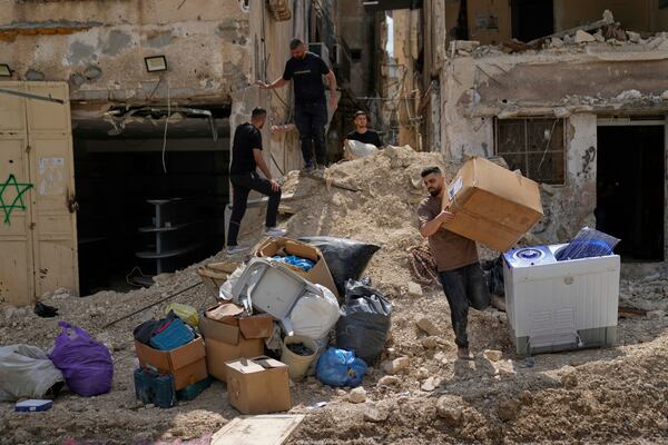Residents of the now evacuated refugee camp of Tulkarem return to collect belongings before the destruction of their homes as Israeli forces prepare to carry out the demolition of 116 homes across the two refugee camps of the Israeli occupied West Bank city of Tulkarem, Friday, May 2, 2025. (AP Photo/Nasser Nasser)