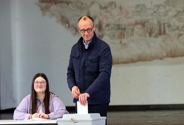 Friedrich Merz, leader of the Christian Democratic Union (CDU), casts his vote at a polling station Arnsberg-Niedereimer, Germany, Sunday, Feb. 23, 2025, during the national election. (Oliver Berg/dpa via AP)