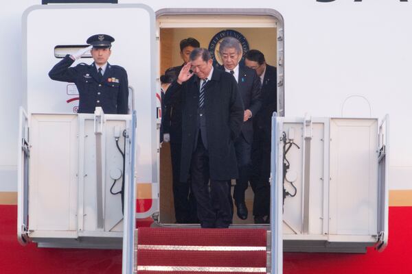 Japan's Prime Minister Shigeru Ishiba salutes as he arrives at Joint Base Andrews, Md., Thursday, Feb. 6, 2025. (AP Photo/Kevin Wolf)