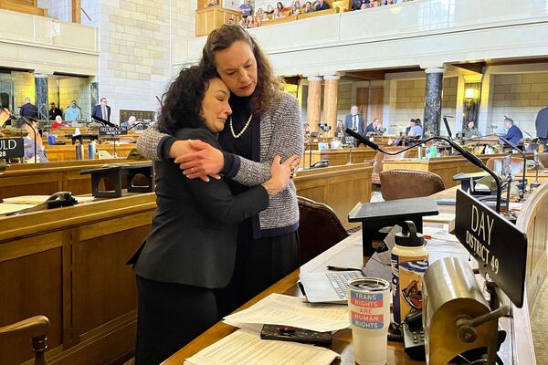 FILE - Nebraska Sens. Jen Day, left, and Danielle Conrad, hug on the floor of the Nebraska Legislature during emotional debate of a bill that would ban gender-affirming care for anyone 18 and younger in the state in Lincoln, Neb., March 23, 2023. The contentious bill advanced despite a threat by several lawmakers, including Day and Conrad, to filibuster the rest of the session if it moved forward. (AP Photo/Margery Beck, File)