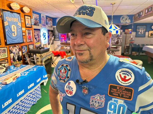 Detroit Lions NFL football fan Rob Gonzales speaks to a reporter while standing in the basement of his home Thursday, Jan. 16, 2025, in Frenchtown Township, Mich.(AP Photo/Mike Householder)