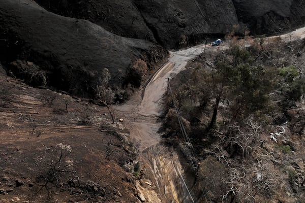 Mud covers Topanga Canyon Rd. on the Palisades Fire burn area after a series of weekend storms Monday, Jan. 27, 2025 near Malibu, Calif. (AP Photo/Jae C. Hong)