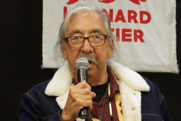 Leonard Peltier, center, a Native American activist released from a Florida prison where he had been serving a life sentence in the 1975 killings of two FBI agents, speaks to the crowd during a welcome event, Wednesday, Feb. 19, 2025, at the Sky Dancer Casino Resort near Belcourt, N.D., on the Turtle Mountain Reservation. (AP Photo/Jack Dura)