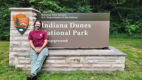 This July 2024 photo provided by Eric Anderson shows Eric Anderson at an entrance to the Indiana Dunes National Park in Porter, Ind. (Eric Anderson via AP)