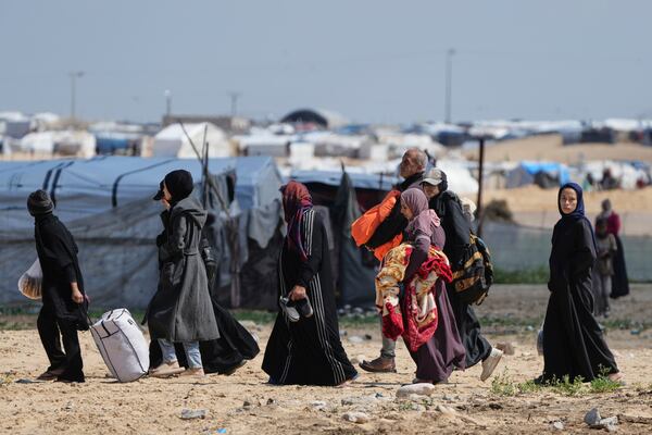 Displaced Palestinians, who flee from Rafah amidst ongoing Israeli military operations following Israel's renewed offensive in the Gaza Strip, arrive in Khan Younis, Gaza, on Sunday, March 23, 2025. (AP Photo/Abdel Kareem Hana)