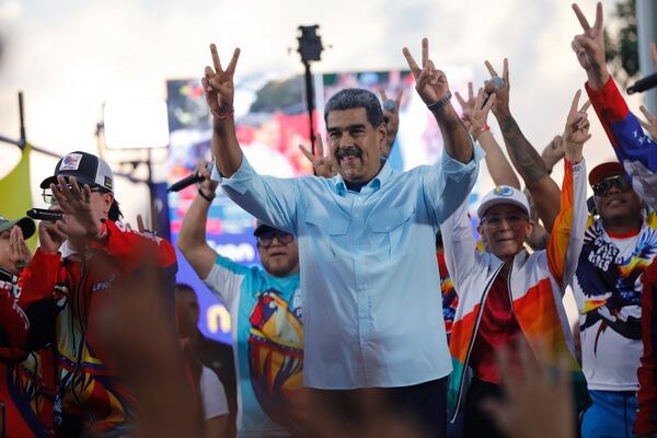 FILE - Venezuelan President Nicolas Maduro flashes victory hand signs at supporters during a pro-government rally, in Caracas, Venezuela, Aug. 17, 2024. (AP Photo/Cristian Hernandez, File)