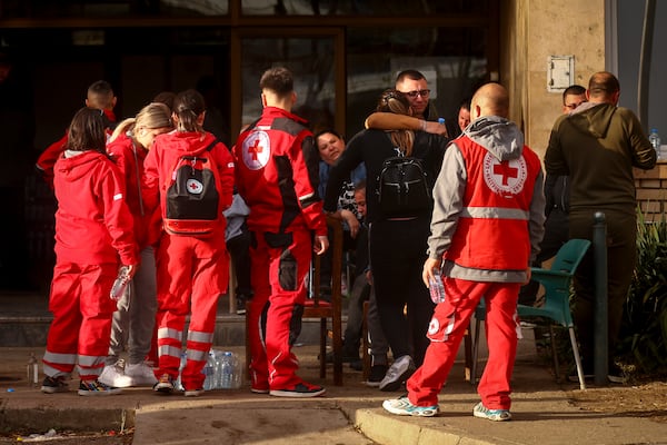 People hug outside a hospital in the town of Kocani, North Macedonia, Sunday, March 16, 2025, following a massive fire in the nightclub early Sunday. (AP Photo/Armin Durgut)