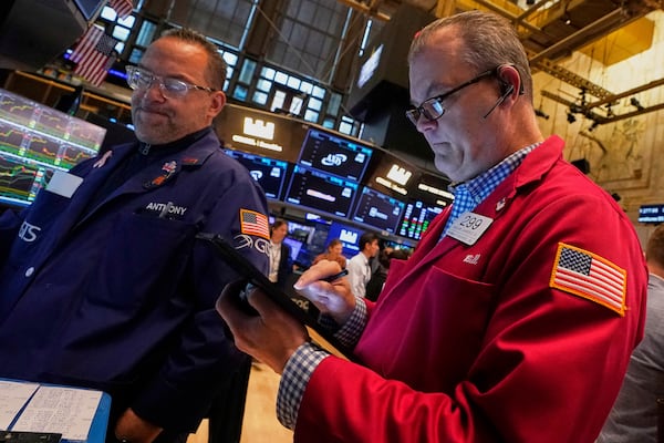 Specialist Anthony Matesic, left, and trader William Lawrence work on the floor of the New York Stock Exchange, Friday, May 2, 2025. (AP Photo/Richard Drew)