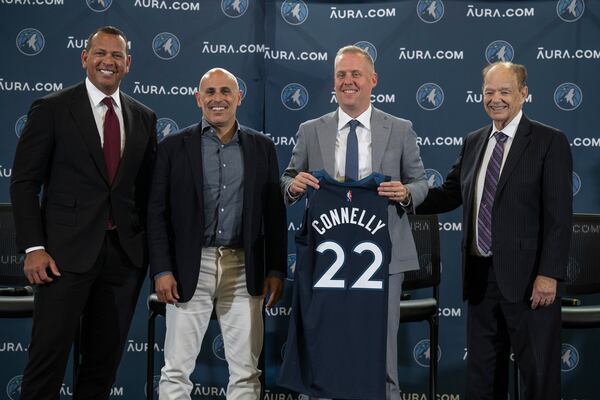 FILE - Minnesota Timberwolves Ownership Group Alex Rodriguez, left, Marc Lore,, second from left, and Glen Taylor, right, pose with Timberwolves new President of Basketball Operations Tim Connelly (holding jersey) in Minneapolis, May 31, 2022. (Jerry Holt/Star Tribune via AP)