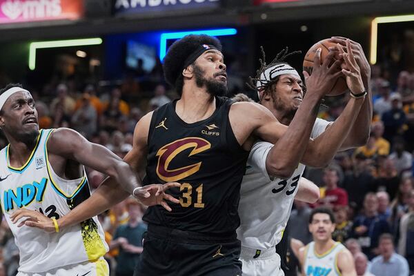 Cleveland Cavaliers center Jarrett Allen battles for the ball between Indiana Pacers center Myles Turner (33) and forward Pascal Siakam in the first half of Game 4 in the Eastern Conference semifinals of the NBA basketball playoffs in Indianapolis, Sunday, May 11, 2025. (AP Photo/Michael Conroy)