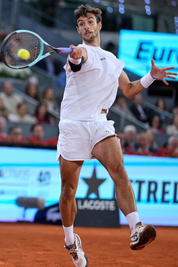 Lorenzo Musetti of Italy returns the ball against Jack Draper of Great Britain during men's semifinal at the Madrid Open tennis tournament in Madrid, Spain, Friday, May 2, 2025. (AP Photo/Manu Fernandez)