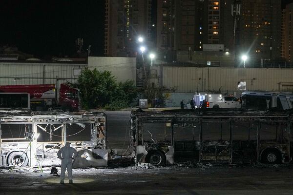 Israeli police inspect the scene of one of a series of bus explosions in what authorities said appeared to be a militant attack in Bat Yam, central Israel, Thursday, Feb. 20, 2025. (AP Photo/Ohad Zwigenberg)