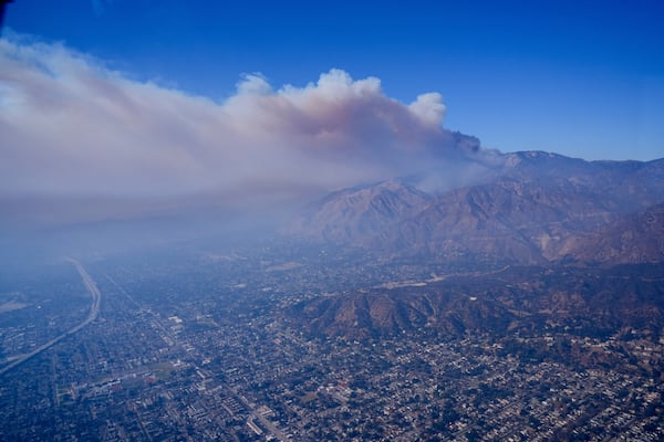 A plume of smoke from a wildfire forms over the city's basin Thursday, Jan. 9, 2025 in Los Angeles. (AP Photo/Mark J. Terrill)