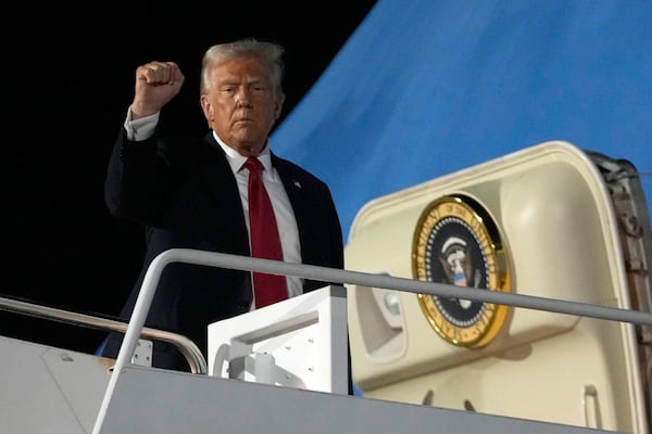 President Donald Trump boards Air Force One at the Naval Air Station Joint Reserve Base in New Orleans, Sunday, Feb. 9, 2025. (AP Photo/Ben Curtis)