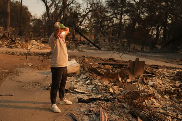 A man reacts to encountering the remains of a fire-ravaged property in the aftermath of the Eaton Fire Thursday, Jan. 9, 2025 in Altadena, Calif. (AP Photo/Eric Thayer)