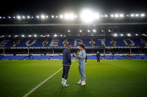 Everton's Ashley Young, left, speaks with his son, Peterborough United's Tyler Young, before the Emirates FA Cup third round match at Goodison Park, Liverpool, England, Thursday Jan. 9, 2025. (Peter Byrne/PA via AP)