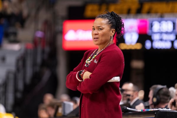 South Carolina head coach Dawn Staley grimaces as she watches her team play during the first half of an NCAA college basketball game against Missouri Thursday, Jan. 2, 2025, in Columbia, Mo. South Carolina won 83-52. (AP Photo/L.G. Patterson)