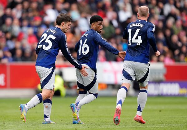 Manchester United's Amad Diallo, center, celebrates scoring their side's third goal of the game during the English Premier League soccer match between Brentford and Manchester United at the Gtech Community Stadium, London, Sunday, May 4, 2025. (John Walton/PA via AP)