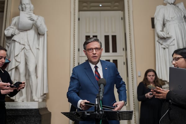 Speaker of the House Mike Johnson, R-La., talks briefly to reporters just before a vote on an interim spending bill to prevent a government shutdown, at the Capitol in Washington, Thursday, Dec. 19, 2024. (AP Photo/J. Scott Applewhite)