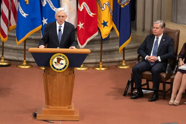 Attorney General Merrick Garland speaks as FBI Director Christopher Wray listens during a farewell ceremony at the Department of Justice, Thursday, Jan. 16, 2025, in Washington. (AP Photo/Mark Schiefelbein)