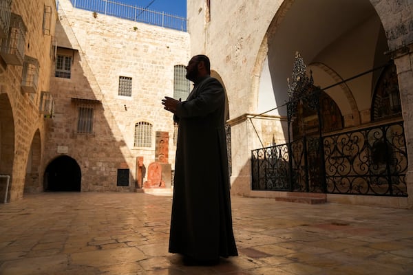 Chancellor of the Armenian Patriarchate of Jerusalem Father Aghan Gogchyan gestures outside St. James Cathedral at the Armenian quarter in Jerusalem, Thursday, Nov. 21, 2024. (AP Photo/Francisco Seco)