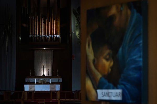 A painting with the word "sanctuary" on it is displayed on the doors of the Augustana Lutheran Church on Thursday, Jan. 9, 2025, in Portland, Ore. (AP Photo/Jenny Kane)