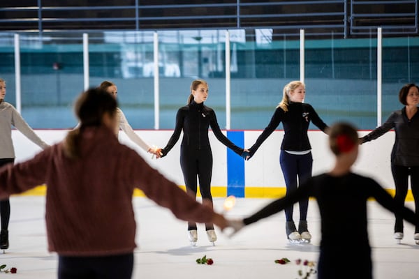 The Cottonwood Heights Figure Skating Club, in unity with skating clubs nationwide and U.S. Figure Skating, holds a vigil for victims Monday, Feb. 3, 2025, at the Cottonwood Heights Recreation Center in Cottonwood Heights, Utah, after an American Airlines jet collided with a military helicopter near Washington’s Reagan National Airport. (Tess Crowley/The Deseret News via AP)