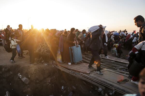 Displaced Palestinians arrive in the northern Gaza Strip, following Israel's decision to allow thousands of them to go back for the first time since the early weeks of the 15-month war with Hamas, Monday, Jan. 27, 2025. (AP Photo/Jehad Alshrafi)