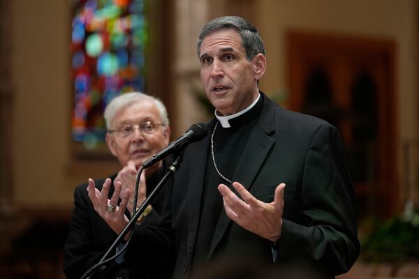 CORRECTS DATE - Bishop Lawrence J. Sullivan, vicar general of the Archdiocese of Chicago, speaks as Father Gregory Sakowicz listens at Holy Name Cathedral, on Thursday, May 8, 2025, in Chicago. (AP Photo/Erin Hooley)