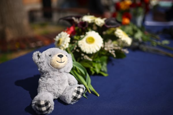 A toy and flowers are placed next to condolence books for the victims of a massive nightclub fire in the town of Kocani, North Macedonia, Monday, March 17, 2025, (AP Photo/Armin Durgut)