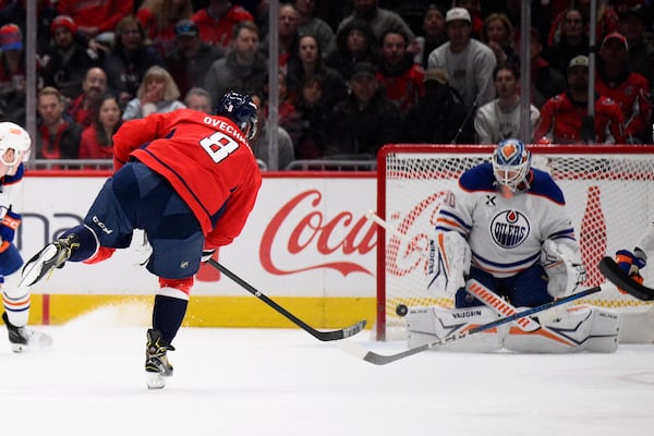 Washington Capitals left wing Alex Ovechkin (8) scores against Edmonton Oilers goaltender Calvin Pickard (30) during the second period of an NHL hockey game, Sunday, Feb. 23, 2025, in Washington. (AP Photo/Nick Wass)