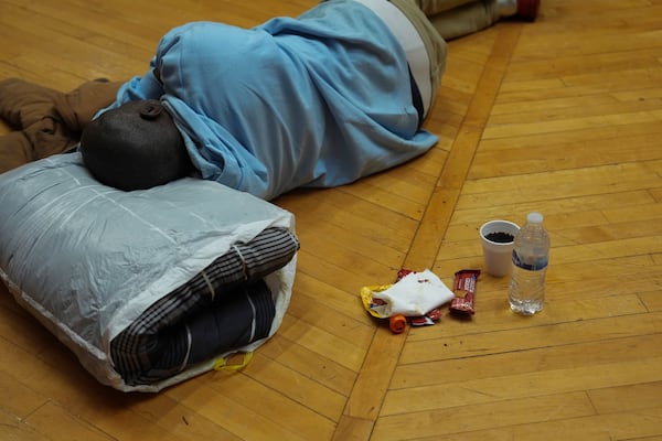 A person rests inside a daytime warming center, Tuesday, Jan. 7, 2025, in Cincinnati. (AP Photo/Joshua A. Bickel)